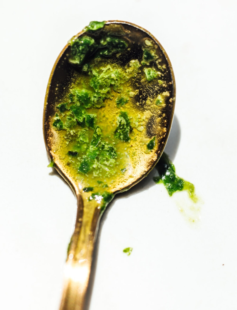 basil vinaigrette on a gold spoon