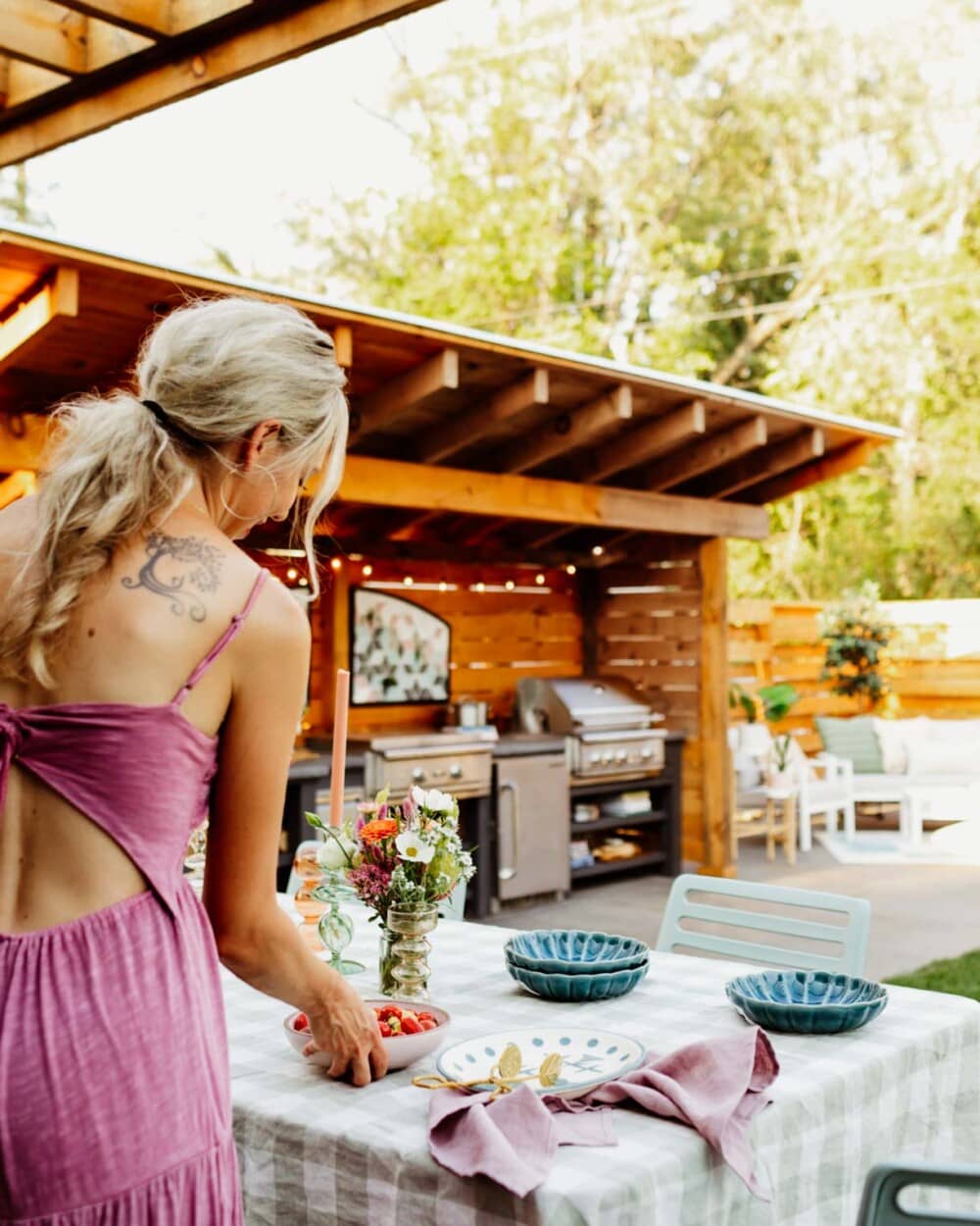 woman setting outdoor patio table