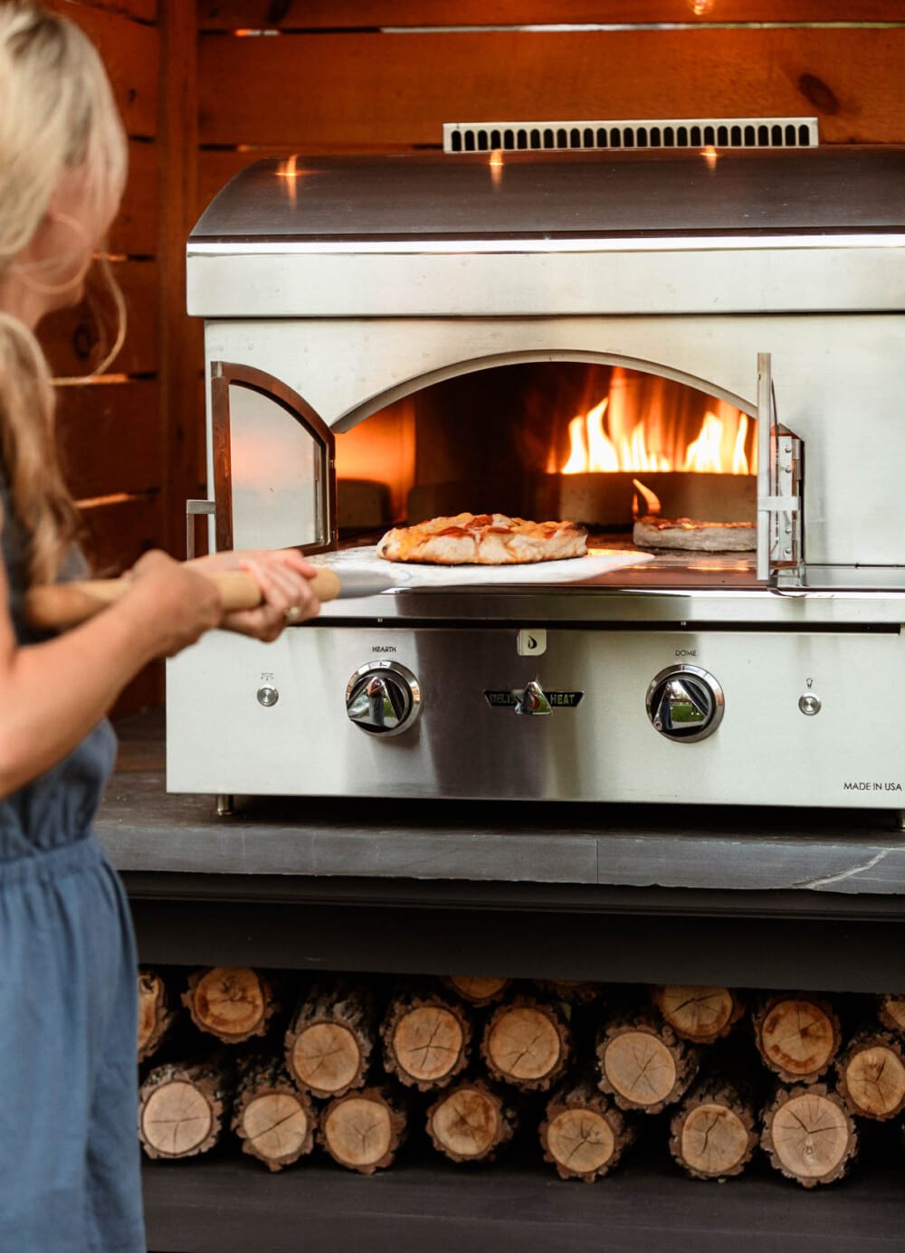 delta heat pizza oven in use in an outdoor kitchen