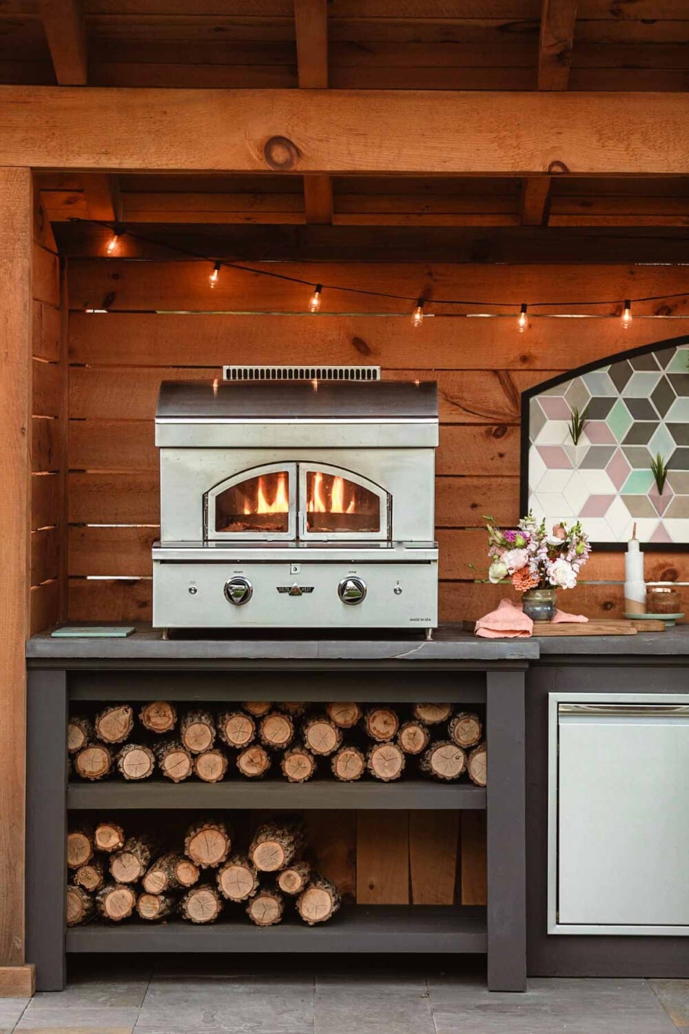 delta heat pizza oven in use in an outdoor kitchen