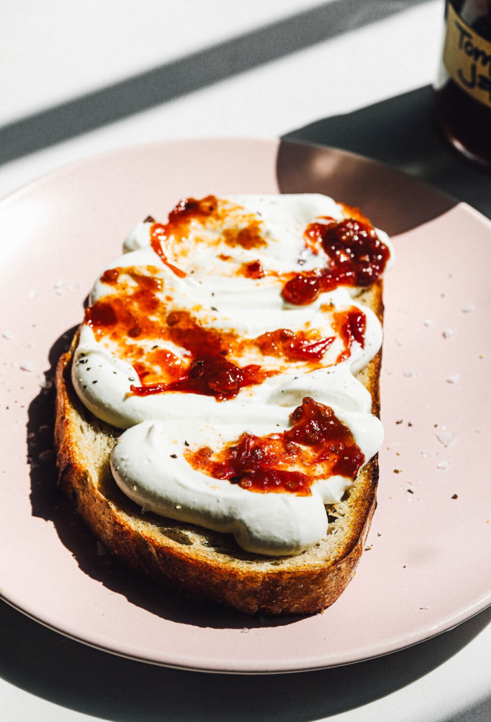 piece of toast with whipped ricotta and tomato jam