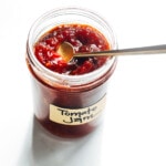 tomato jam in a jar with gold spoon