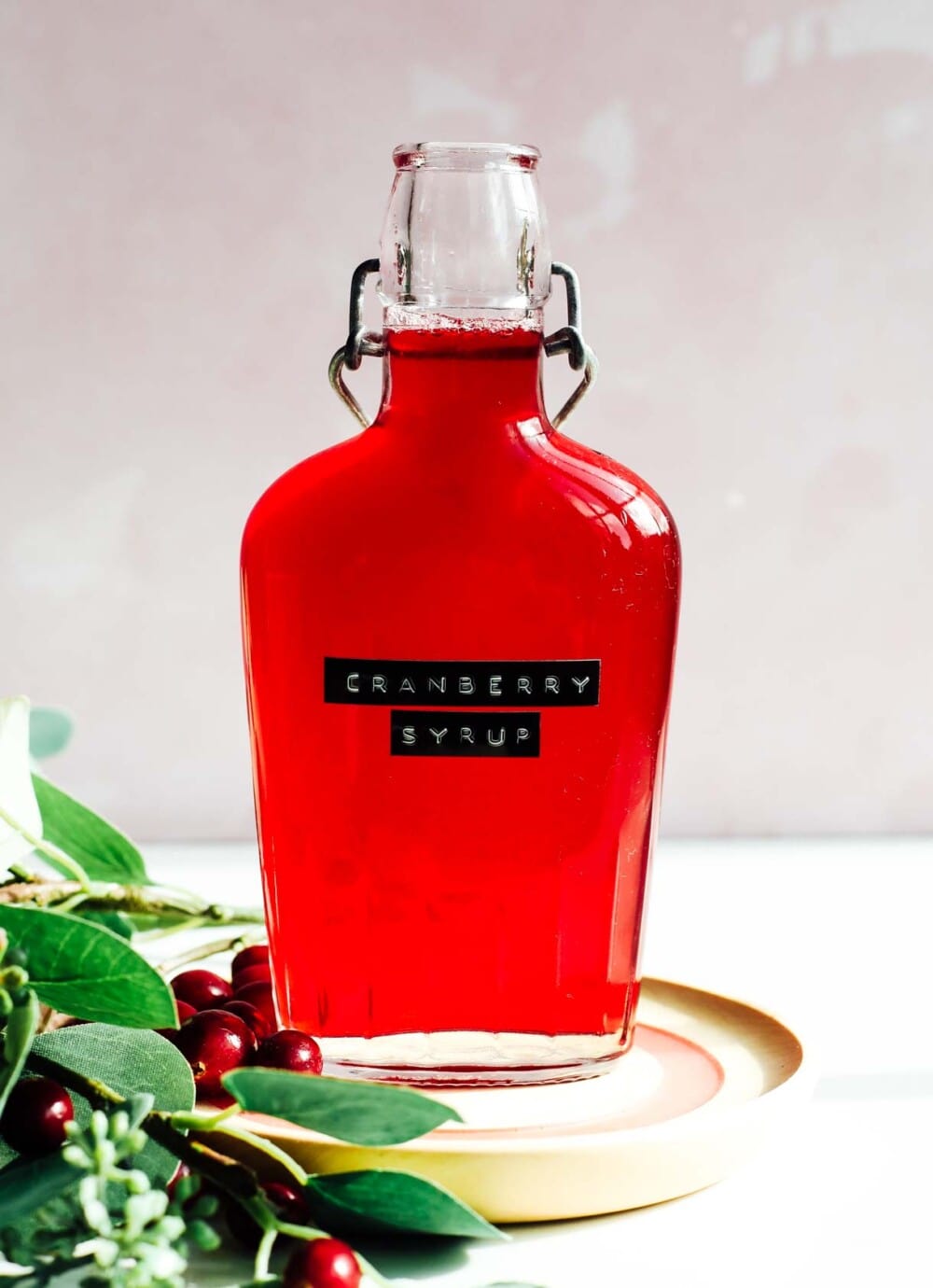 cranberry simple syrup in a glass bottle