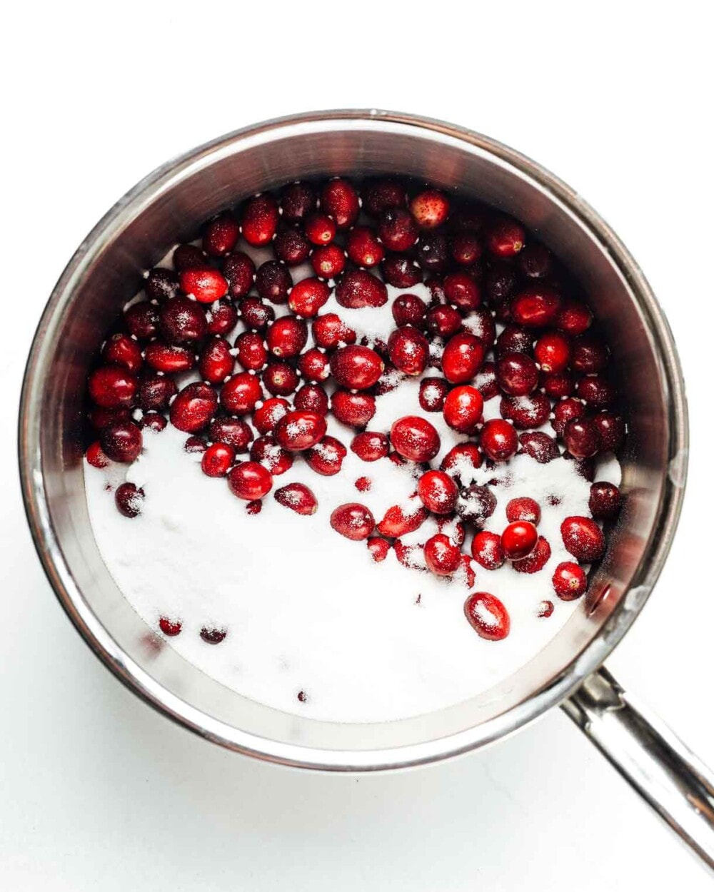 cranberries and sugar in stainless steel pot