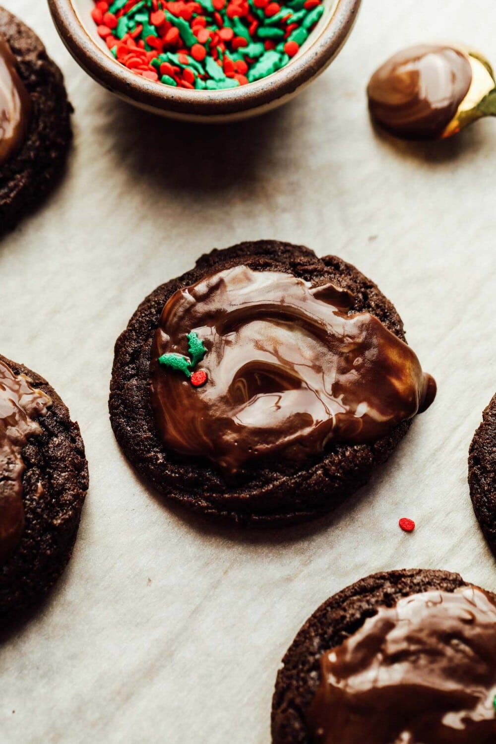 gluten free chocolate mint cookies on parchment paper with sprinkles