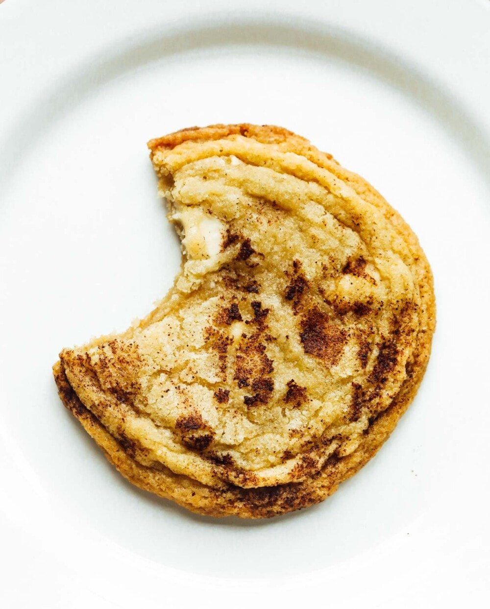 a gluten free snickerdoodle with bite out of it 