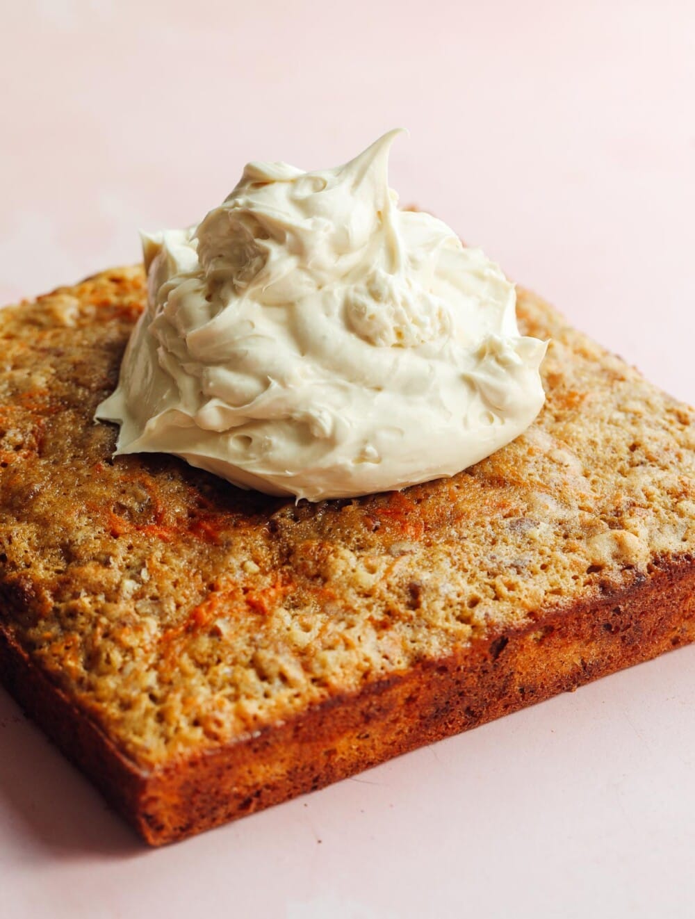 carrot cake bars with frosting piled on top