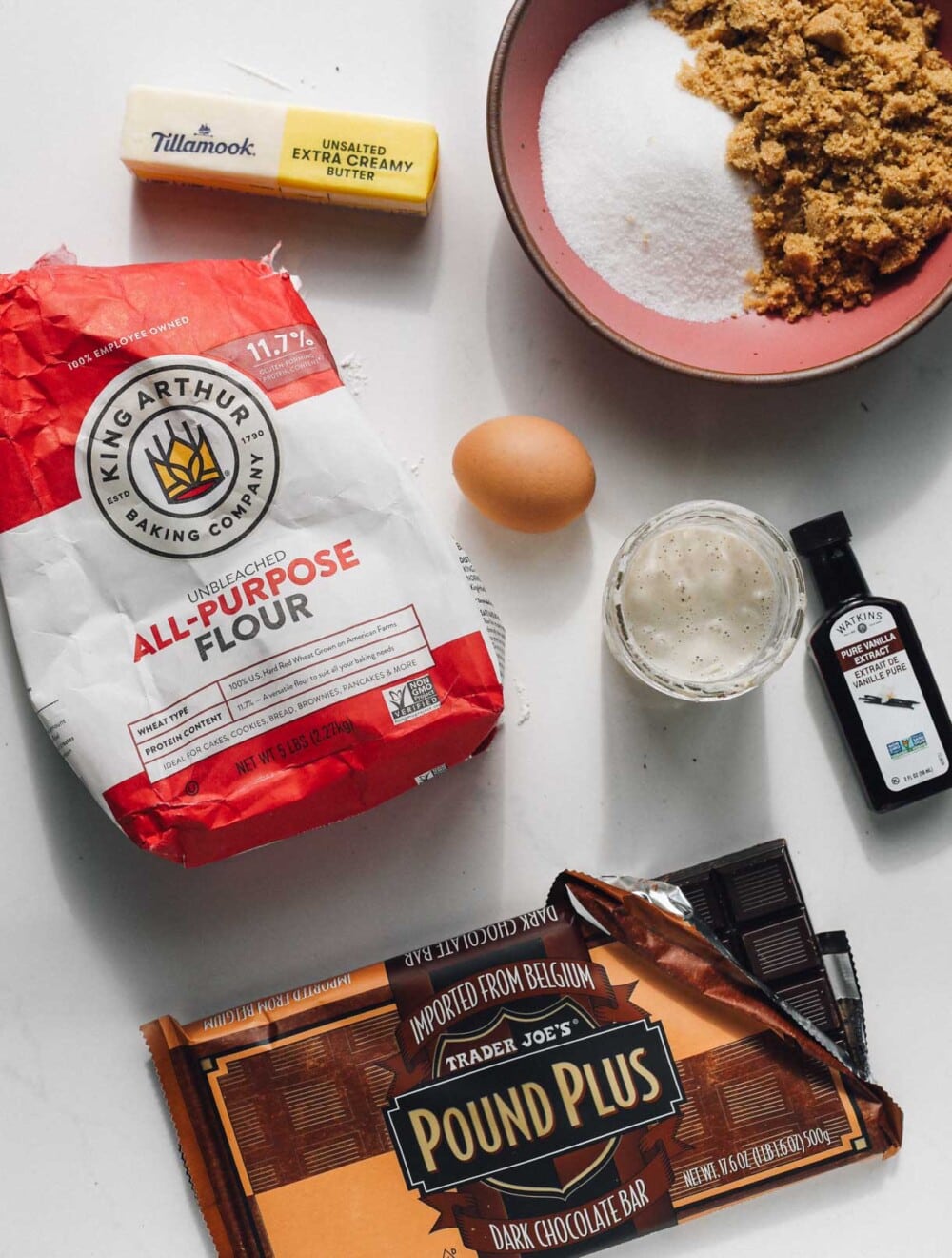 ingredients to make sourdough chocolate chip cookies on white surface