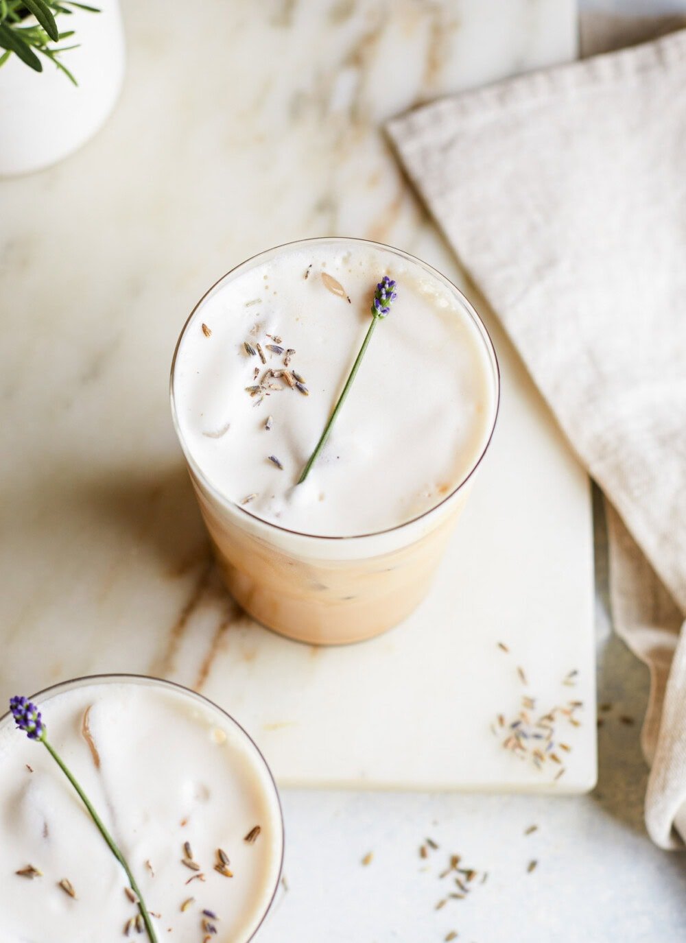 top down photo of iced lavender iced latte in clear glass