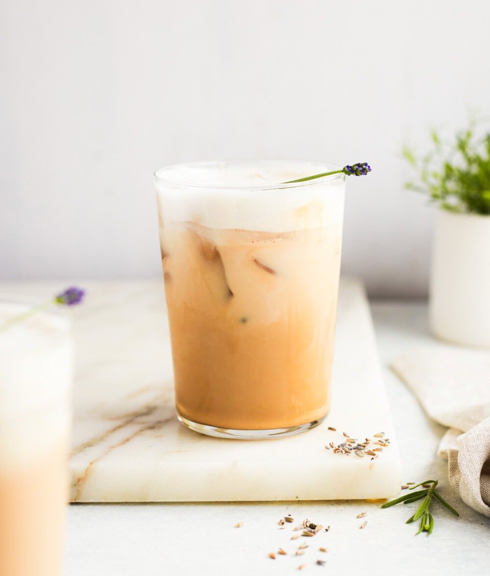 lavender iced latte in a clear glass