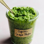 garlic scape pesto in a jar with a label.