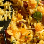 butternut squash orzo in a pan with a spoon