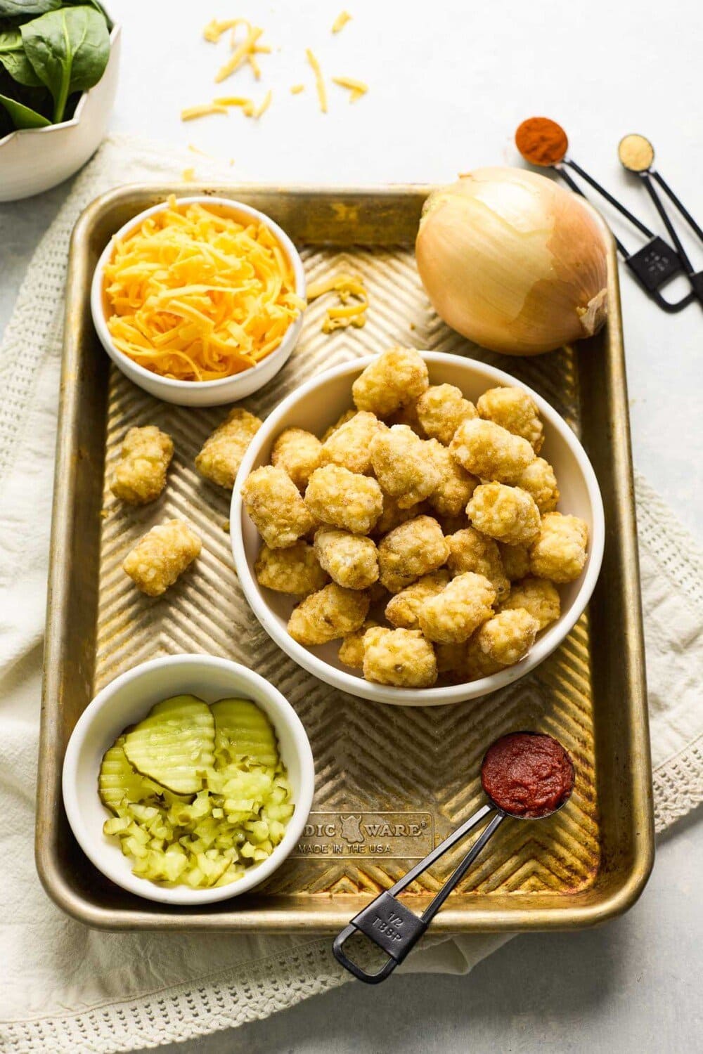 ingredients for sloppy joe casserole on a sheet pan