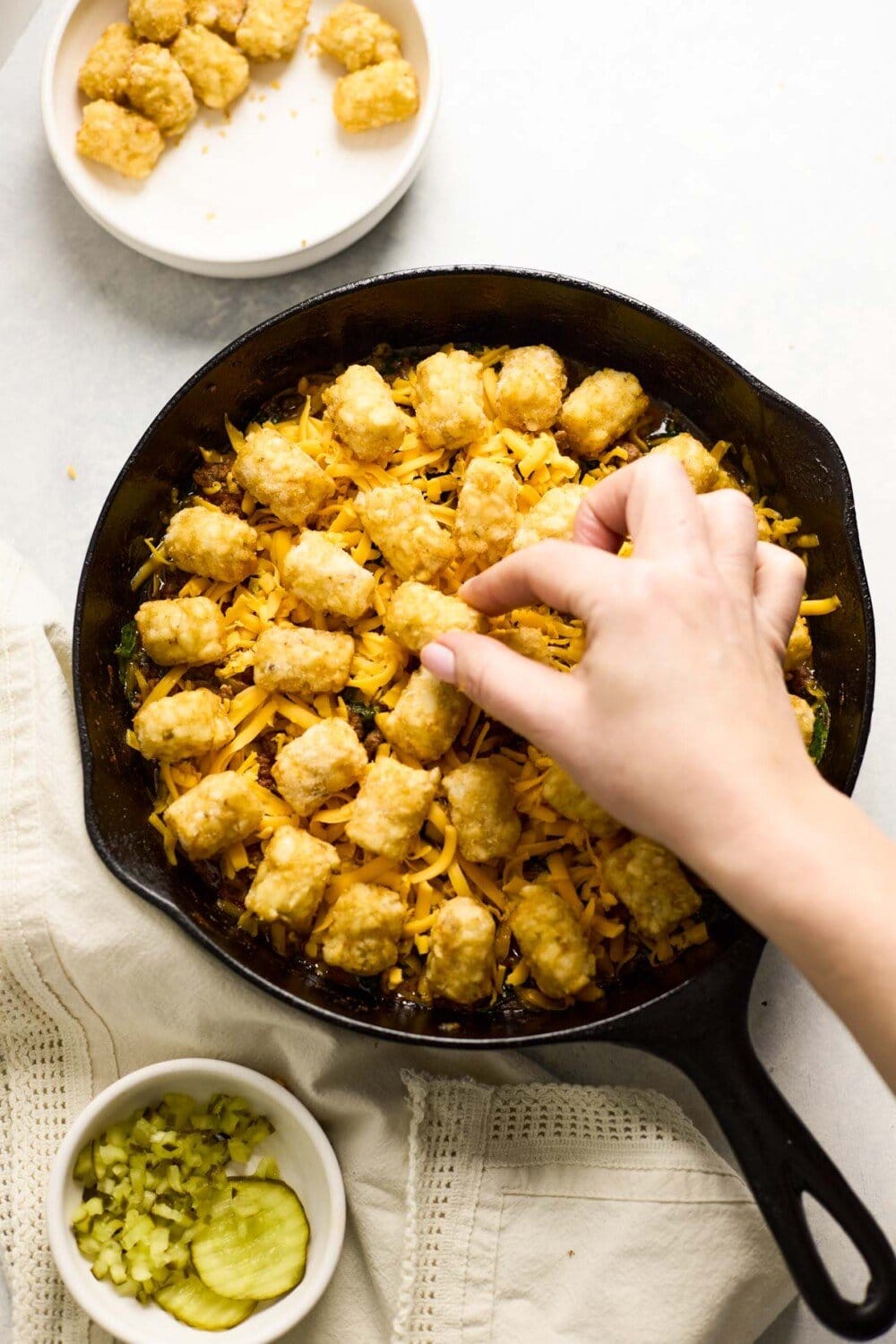 putting tater tots onto tater tot casserole