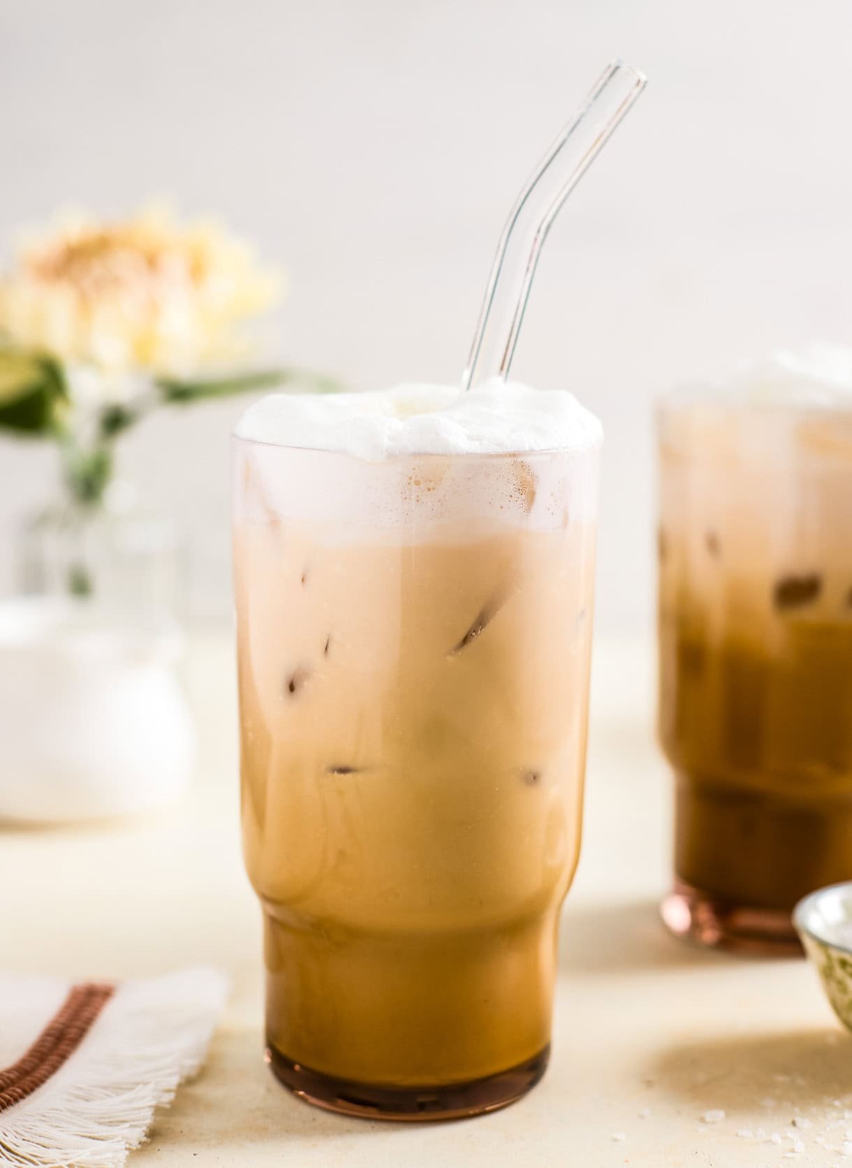 iced vanilla latte with a glass straw