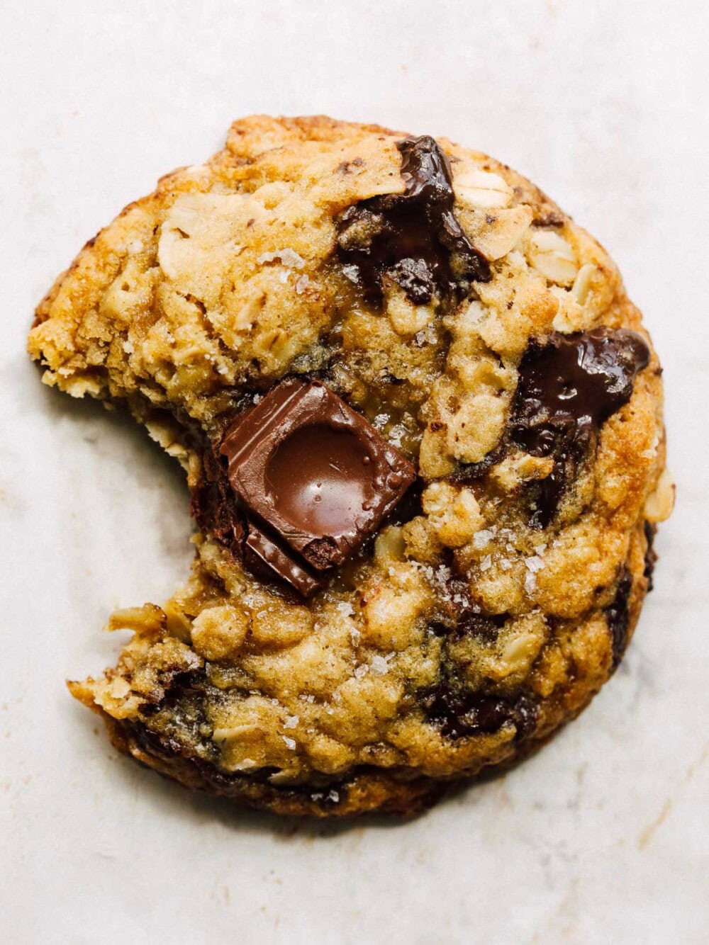 sourdough oatmeal chocolate chip cookie with bite out of it