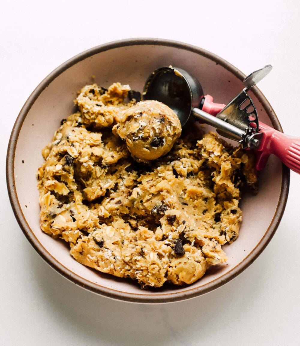 oatmeal chocolate chip cookie dough in a pink bowl