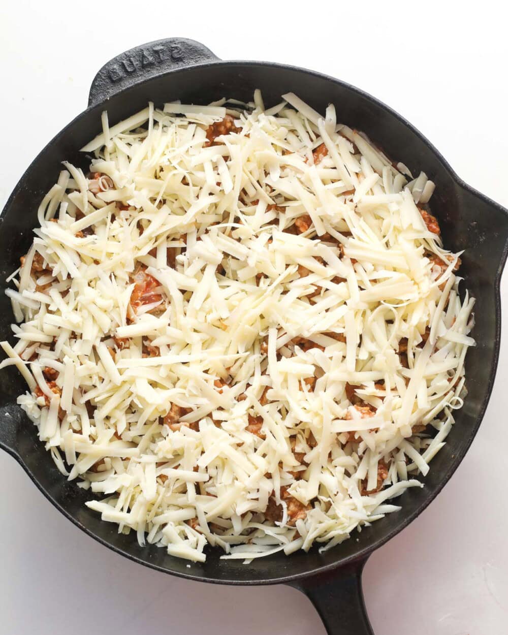 turkey casserole topped with cheese before being baked