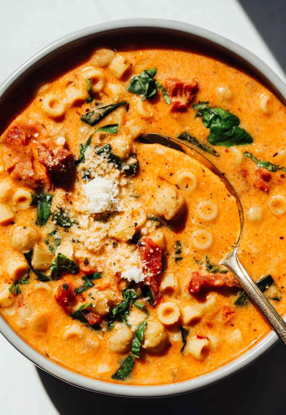 marry me chickpea soup in a bowl with gold spoon