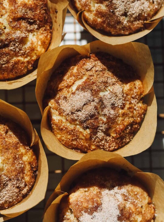 sourdough apple muffins in paper liners on cooling rack