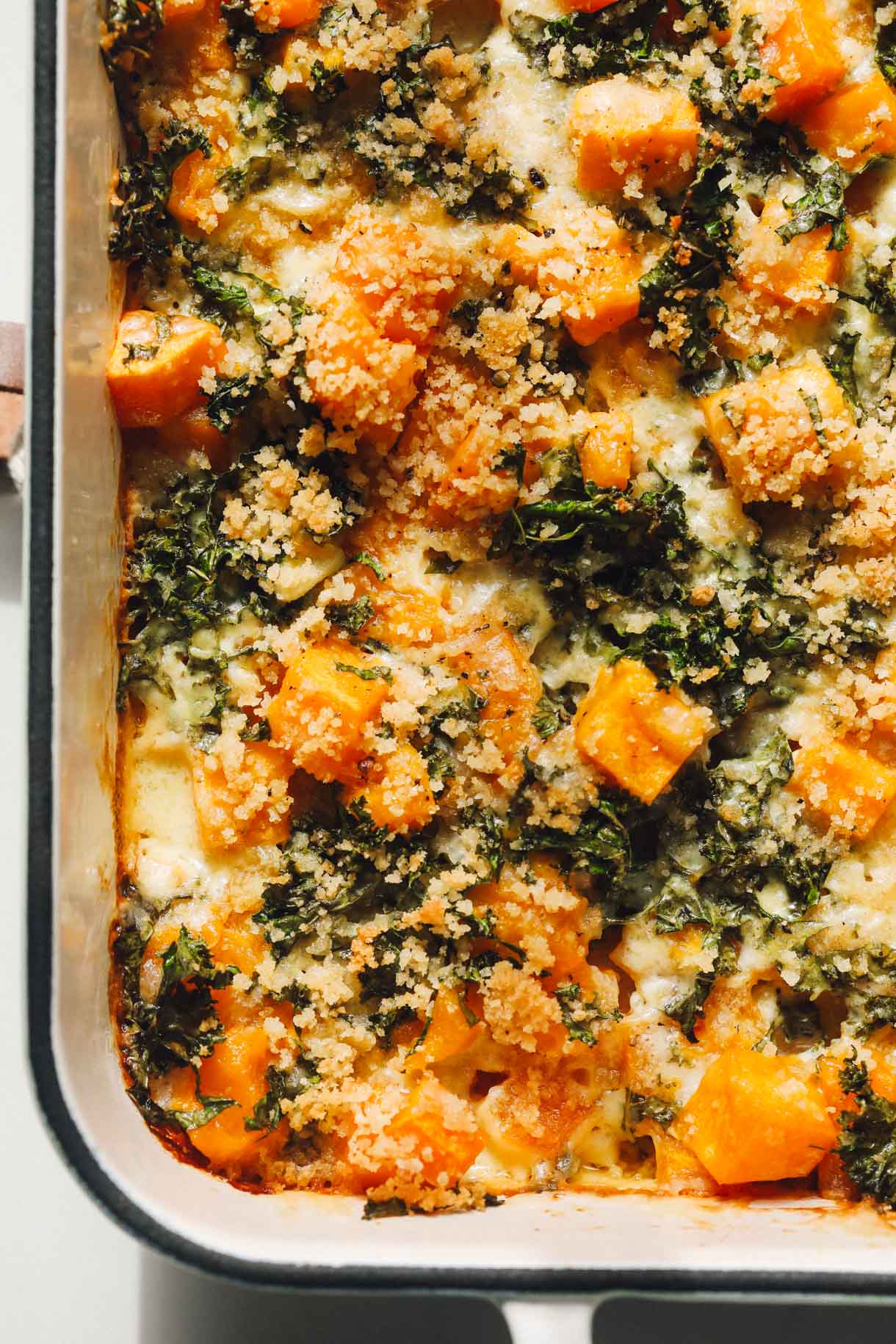 butternut squash casserole in a white baking dish