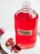 rhubarb simple syrup in glass bottle with label on it