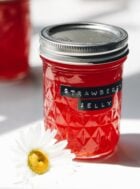 strawberry jelly in a mason jar with label