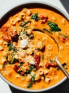 marry me chickpea soup in a bowl with gold spoon